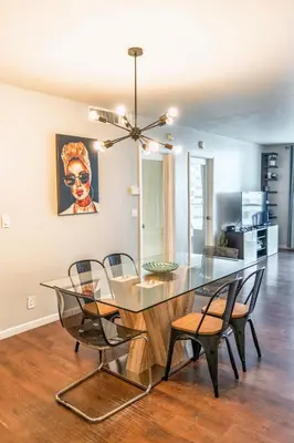 a dining room with a glass table and chairs at Dream Vacation Apartment Right On The Beach in Hollywood