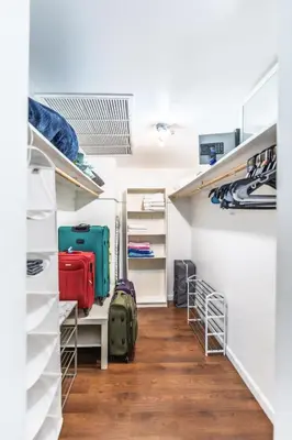 a room with luggage on shelves and a hallway at Dream Vacation Apartment Right On The Beach in Hollywood