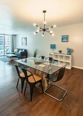 a living room with a dining table and chairs at Dream Vacation Apartment Right On The Beach in Hollywood