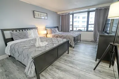 a bedroom with two beds and a window at Deluxe Apartments by South Florida Vacations in Miami Beach