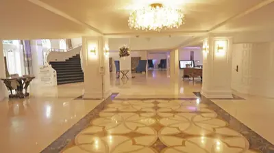 a large lobby with a chandelier and a floor at Deluxe Apartments by South Florida Vacations in Miami Beach