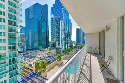 a balcony with chairs and a view of the city at Trendy 2BR Condo with Pool and Bay Views in Miami