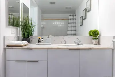 a white bathroom with a sink and a mirror at Beautiful 3 bedroom apartment in Brickell Miami in Miami