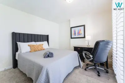 a bedroom with a bed and a chair and a desk at Amazing 3BR Condo at Brickell with City Views in Miami