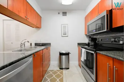 a kitchen with a sink and a stove at Amazing 3BR Condo at Brickell with City Views in Miami