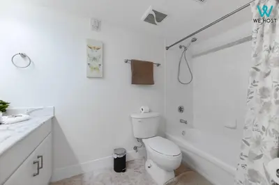a white bathroom with a toilet and a shower at Amazing 3BR Condo at Brickell with City Views in Miami