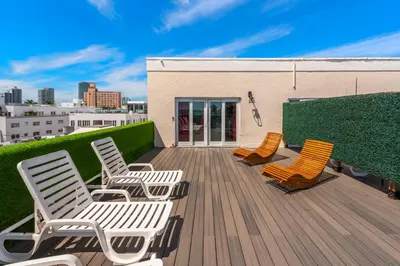 a group of chairs sitting on a wooden deck at SOBE suites in Miami Beach in Miami Beach