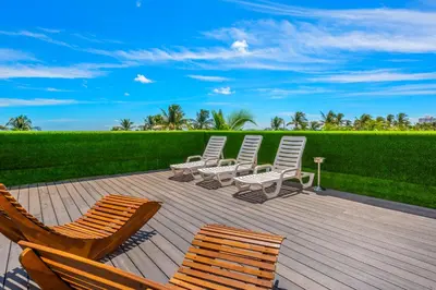 a group of chairs sitting on a wooden deck at SOBE suites in Miami Beach in Miami Beach