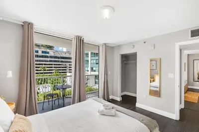 a bedroom with a large bed and a balcony at Luxurious 3BR Condo with Pool in Brickell in Miami