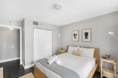 a bedroom with a large white bed and a window at Luxurious 3BR Condo with Pool in Brickell in Miami