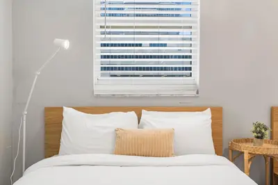 a bedroom with a bed with a window at Luxurious 3BR Condo with Pool in Brickell in Miami