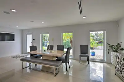 a dining room with a table and chairs at Miami Home Outdoor Pool with Slide and Fire Pit! in Kendall