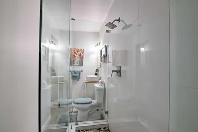 a white bathroom with a toilet and a shower at Miami Home Outdoor Pool with Slide and Fire Pit! in Kendall