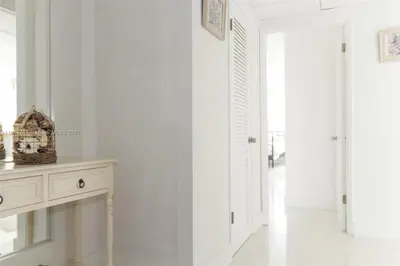 a white room with a table and a hallway at DISFRUTA SUNNY ISLES OCEAn 1206 STR-02816 in Miami Beach