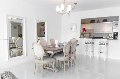 a dining room with a wooden table and chairs at DISFRUTA SUNNY ISLES OCEAn 1206 STR-02816 in Miami Beach