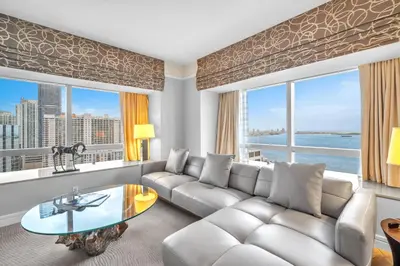 a living room with a couch and a table at 2 Bedroom OR King Studio Suites Four Seasons Hotel Miami Free Wi-Fi & Free Parking in Miami
