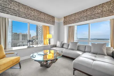a living room with a couch and a table at 2 Bedroom OR King Studio Suites Four Seasons Hotel Miami Free Wi-Fi & Free Parking in Miami