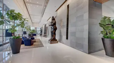 a lobby with plants and a statue in the middle at 2 Bedroom OR King Studio Suites Four Seasons Hotel Miami Free Wi-Fi & Free Parking in Miami