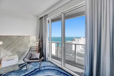 a room with a chair and a large window at WVR Vacation Residences 1707 in Fort Lauderdale