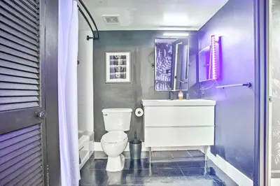 a purple bathroom with a toilet and a sink at Waterfront Condo with View about 6 Miles to South Beach! in Miami