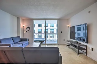 a living room with a couch and a tv at Waterfront Condo with View about 6 Miles to South Beach! in Miami