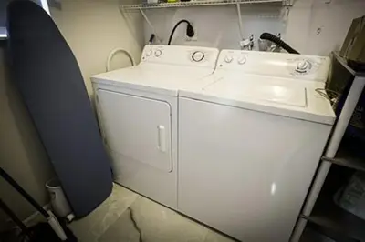 a kitchen with a sink and a washing machine at Hard Rock Hidden Gem! in Miami Gardens