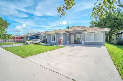 a house in a subdivision with a driveway at Hard Rock Hidden Gem! in Miami Gardens