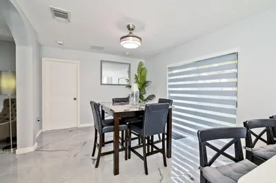 a dining room with a table and chairs at Hard Rock Hidden Gem! in Miami Gardens