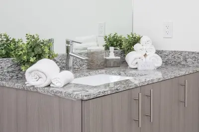 a bathroom counter with a sink and towels on it at Luxury Studio Apartment in Downtown Doral in Miami