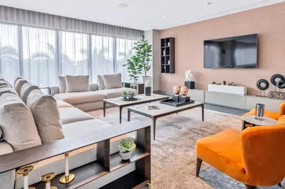 a living room with a couch and a tv at Luxury Studio Apartment in Downtown Doral in Miami