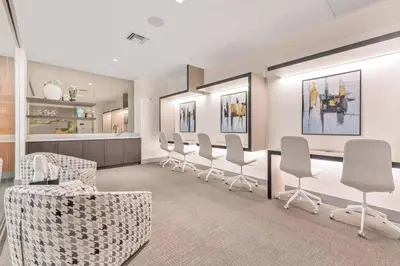 a waiting room with a row of chairs and a counter at Luxury Studio Apartment in Downtown Doral in Miami