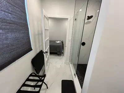 a bathroom with a walk in shower and a mirror at Private Rooms close to Miami Airport - Free parking - 01 in Miami