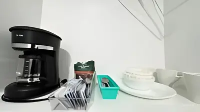 a coffee maker on a counter next to a cup at Private Rooms close to Miami Airport - Free parking - 01 in Miami
