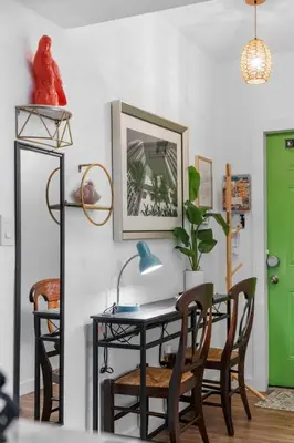 a table and chairs in a room with a green door at Stunning Little Havana Suites Close to airport, Calle Ocho, Brickell, Wynwood and the Beaches - Free Parking in Miami
