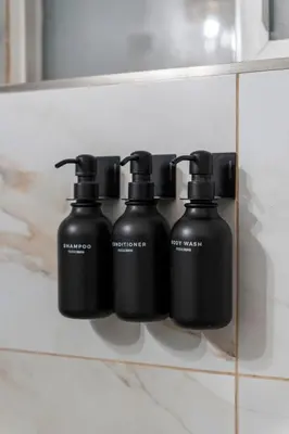 a group of four black bottles on a shelf at Stunning Little Havana Suites Close to airport, Calle Ocho, Brickell, Wynwood and the Beaches - Free Parking in Miami