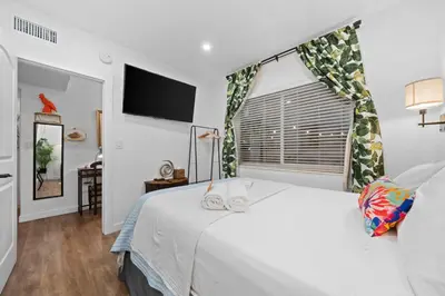 a bedroom with a white bed and a window at Stunning Little Havana Suites Close to airport, Calle Ocho, Brickell, Wynwood and the Beaches - Free Parking in Miami