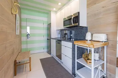 a small kitchen with a counter and a table at Boutique Suite with Huge Terrace and Rooftop Pool in Miami Beach