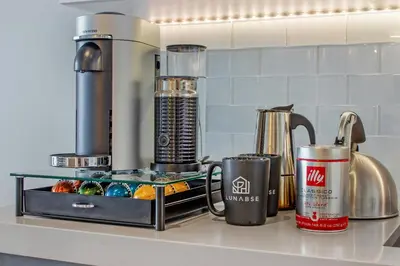 a kitchen counter with a coffee maker and cups on it at Lunabase Heavenly View in Miami