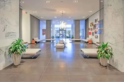 a lobby with couches and plants in a building at Lunabase Heavenly View in Miami