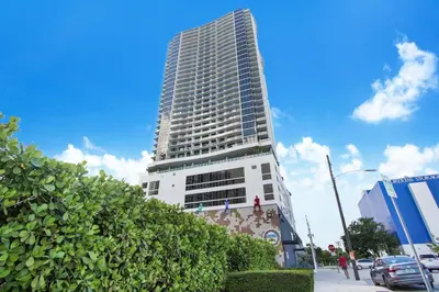 a tall white building in front of a street at Lunabase Heavenly View in Miami