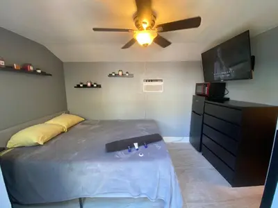 a bedroom with a bed and a ceiling fan at Cozy House in Fort Lauderdale