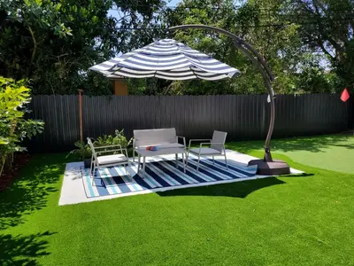 a patio with a table and an umbrella and chairs at Casa Cuba in Little Havana, Brickell, Calle 8 and 10 minutes to the Beach FREE PARKING in Miami