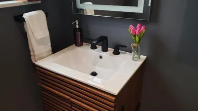 a bathroom sink with a vase of flowers on it at Casa Cuba in Little Havana, Brickell, Calle 8 and 10 minutes to the Beach FREE PARKING in Miami