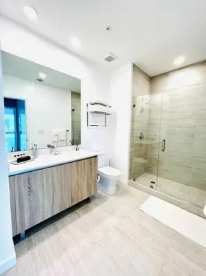 a bathroom with a sink and a toilet and a shower at Sleek 2BD 2BA Condo In Miami Design District in Miami