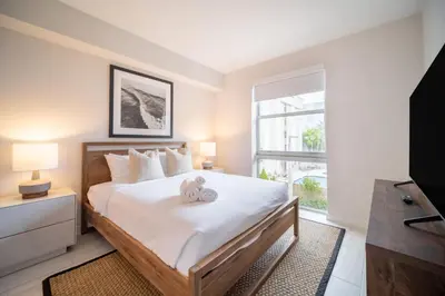 a bedroom with a bed with two teddy bears on it at Tucker at Palmer Dadeland Miami in Miami