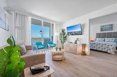 a living room with a couch and a bed at Avi Lux Stay in Fort Lauderdale