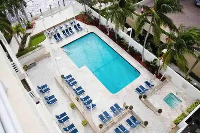an overhead view of a swimming pool with blue lounge chairs at Avi Lux Stay in Fort Lauderdale