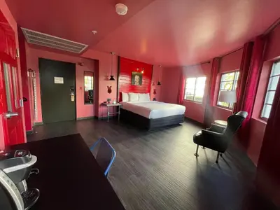 a large red room with a bed and a bathroom at Hotel Gaythering - Gay Hotel - All Adults Welcome in Miami Beach
