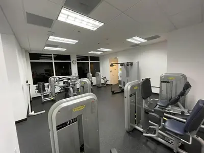 a gym with rows of chairs and machines at Rooftop Pool with Water View in Miami