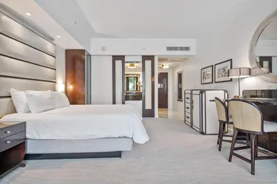 a bedroom with a bed and a desk and a kitchen at Junior Suite 2 at Sorrento Residences- Miami Beach home in Miami Beach